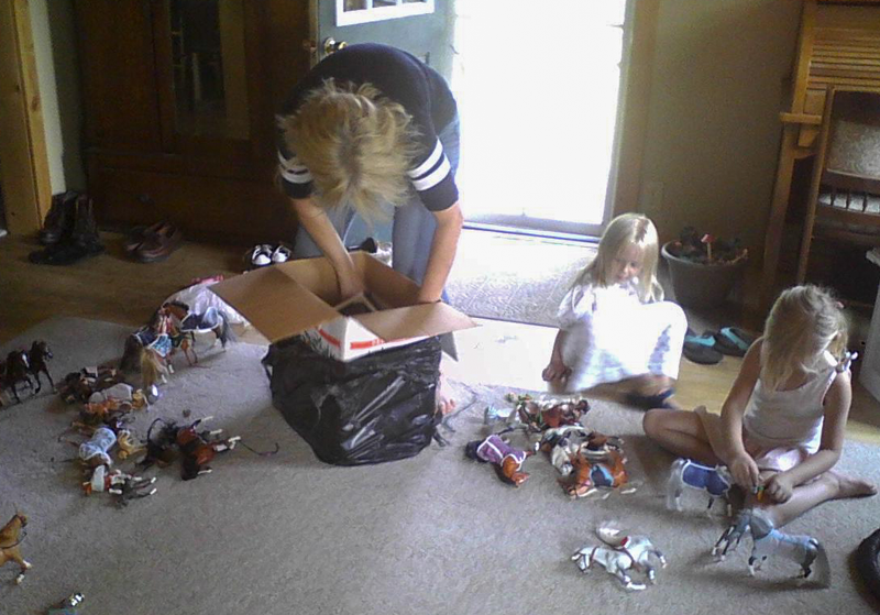 young girls playing with plastic ponies